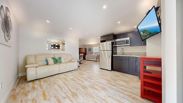 bedroom featuring ceiling fan and light hardwood / wood-style flooring