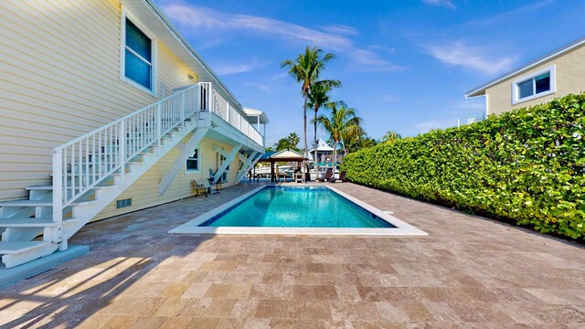 deck with a water view, ceiling fan, and an outdoor hangout area