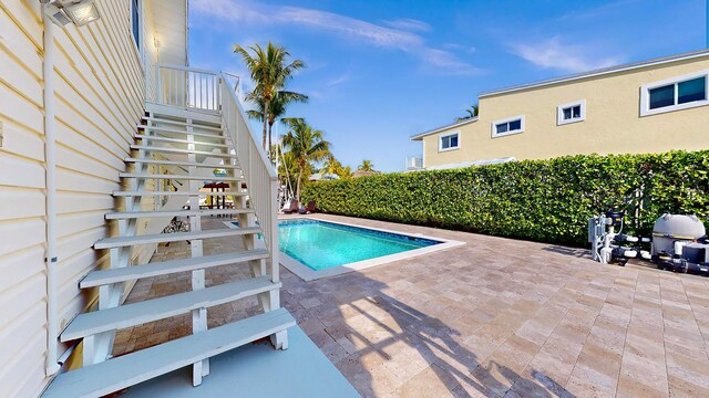 deck featuring a water view, a boat dock, and ceiling fan