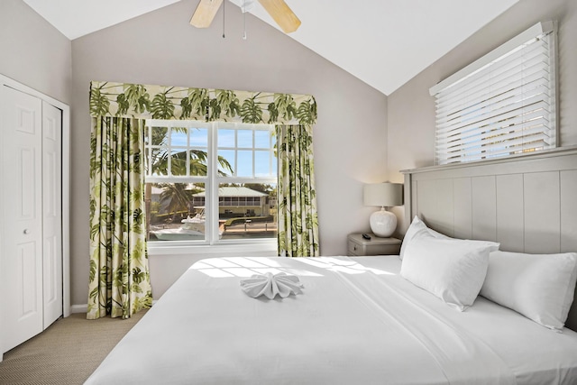 bedroom featuring a closet, lofted ceiling, a ceiling fan, and carpet flooring