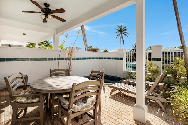 view of patio with outdoor dining area and ceiling fan