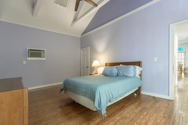 bedroom featuring crown molding, beam ceiling, wood-type flooring, and a wall mounted AC