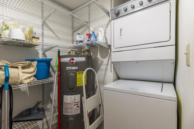 clothes washing area featuring water heater and stacked washer and clothes dryer