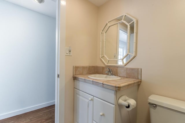 bathroom featuring hardwood / wood-style flooring, vanity, and toilet