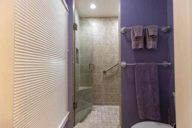 bathroom featuring a shower with door