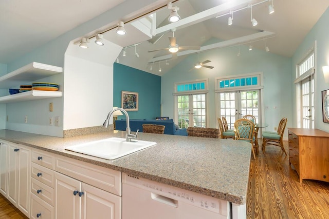 kitchen with french doors, sink, vaulted ceiling, dishwasher, and white cabinets