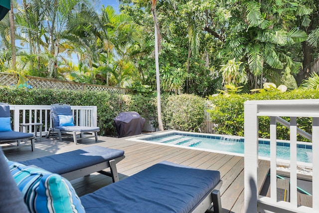 view of swimming pool with area for grilling and a wooden deck