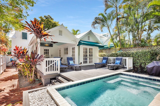 back of property featuring a pool side deck, french doors, and ceiling fan