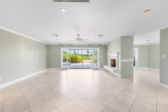 unfurnished living room with crown molding, a brick fireplace, and light tile patterned flooring