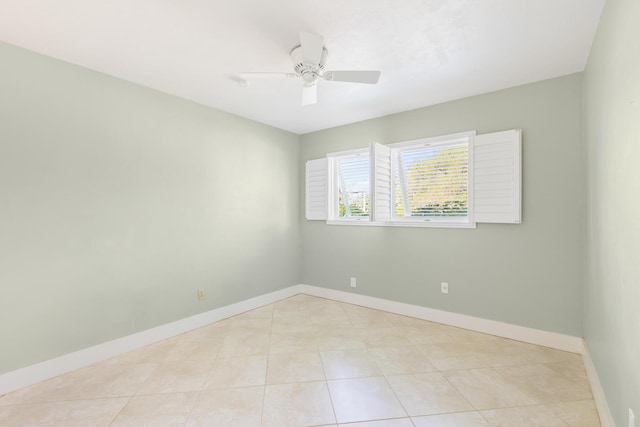 tiled empty room featuring ceiling fan