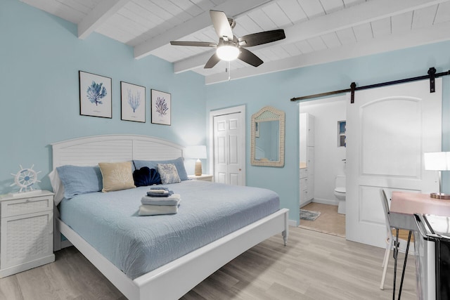 bedroom featuring wooden ceiling, a barn door, beam ceiling, and light wood-type flooring