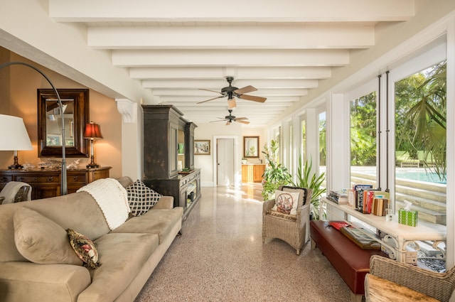 sunroom / solarium with beamed ceiling and ceiling fan