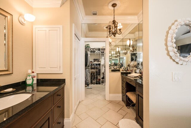 bathroom featuring crown molding, vanity, and an inviting chandelier