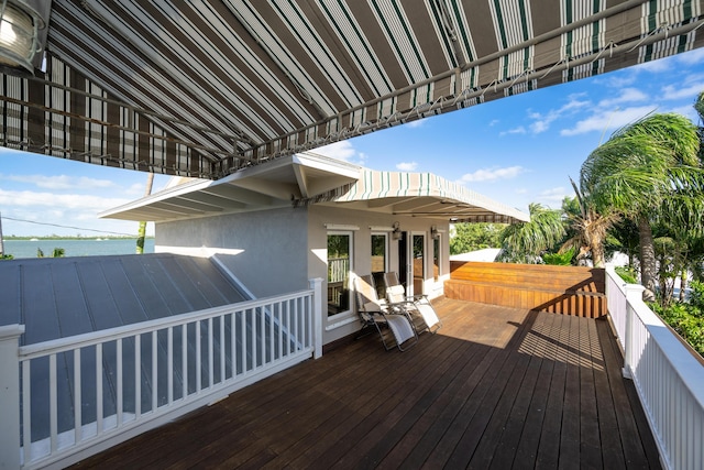 wooden terrace featuring a water view