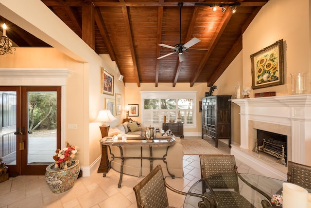 living room featuring ceiling fan, a premium fireplace, lofted ceiling with beams, and wooden ceiling