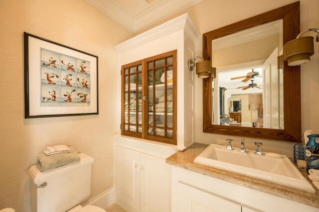 bathroom featuring ornamental molding, vanity, and toilet