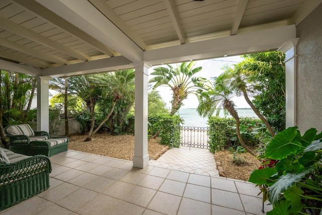 view of patio with a water view and an outdoor hangout area