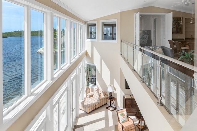 interior space with crown molding, a water view, and lofted ceiling