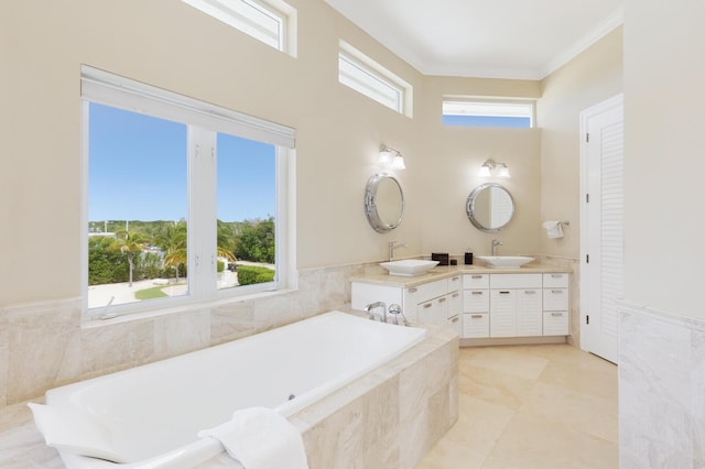 bathroom with vanity, plenty of natural light, ornamental molding, and tile patterned floors