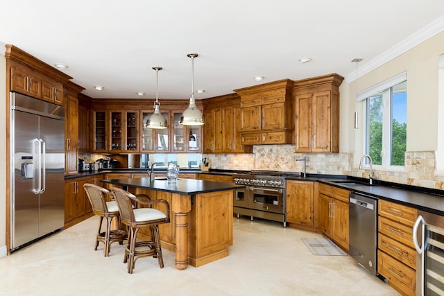 kitchen with wine cooler, a kitchen bar, sink, high quality appliances, and a kitchen island