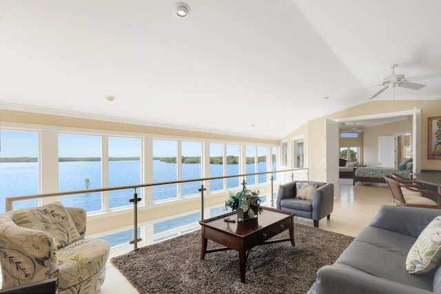 living room with crown molding, vaulted ceiling, ceiling fan, and a water view