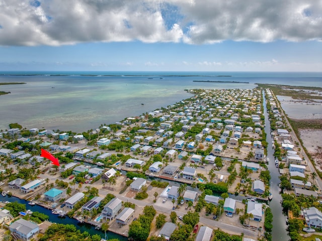 aerial view with a water view and a beach view