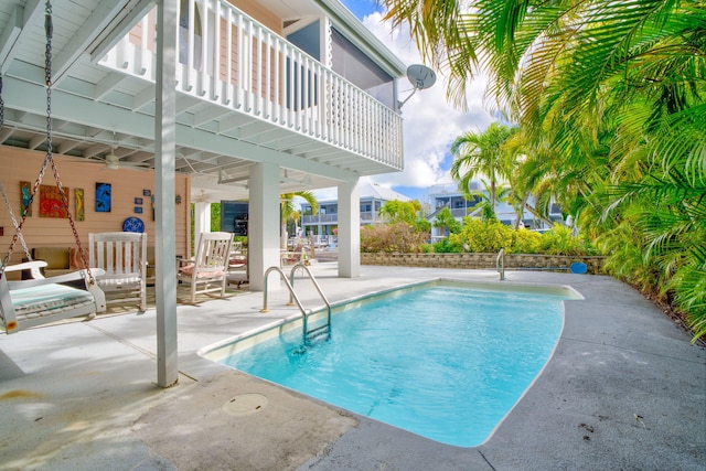 view of swimming pool with a patio and ceiling fan