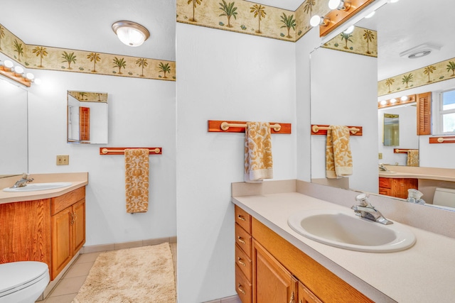 bathroom with tile patterned floors, vanity, and toilet