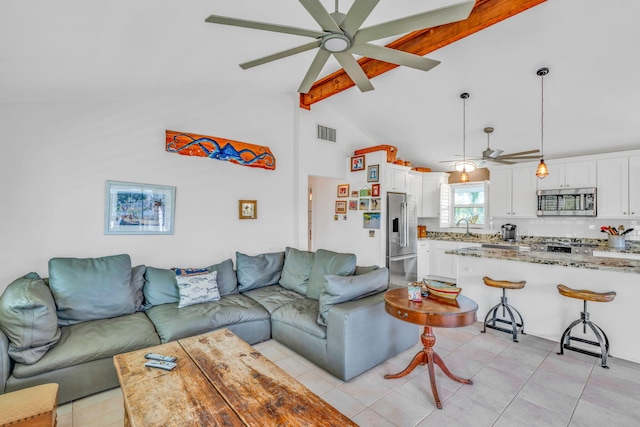 living room featuring lofted ceiling with beams, light tile patterned flooring, sink, and ceiling fan