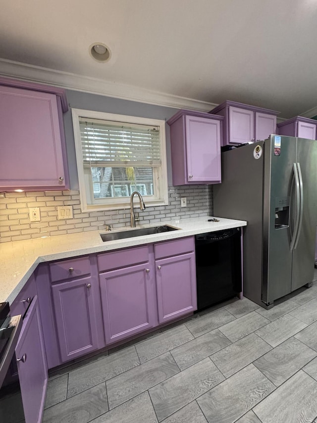 kitchen featuring sink, stainless steel fridge, stove, backsplash, and black dishwasher