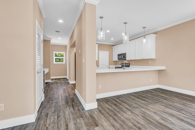 kitchen featuring white cabinetry, baseboards, appliances with stainless steel finishes, and light countertops