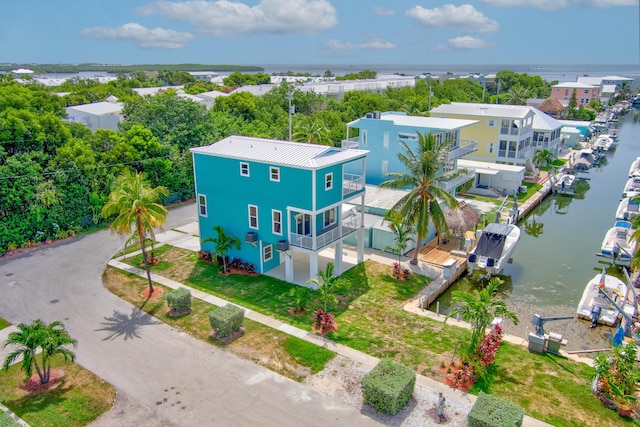 drone / aerial view featuring a water view and a residential view