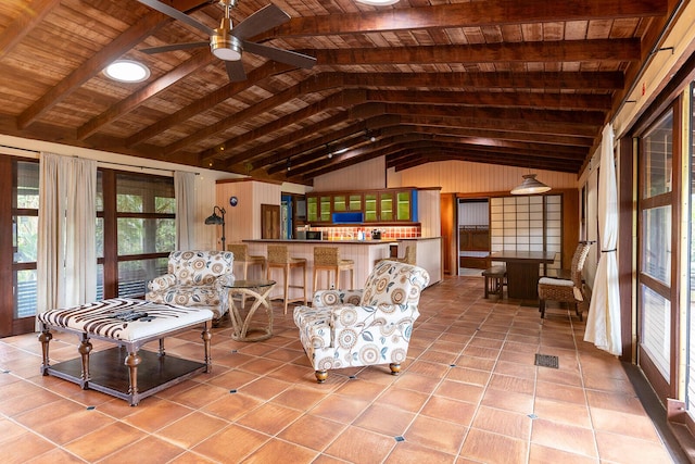 interior space featuring wood ceiling, ceiling fan, vaulted ceiling with beams, wooden walls, and light tile patterned flooring