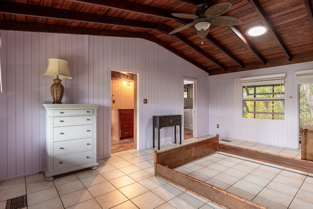 interior space featuring vaulted ceiling with beams, wood ceiling, ensuite bathroom, and light tile patterned floors