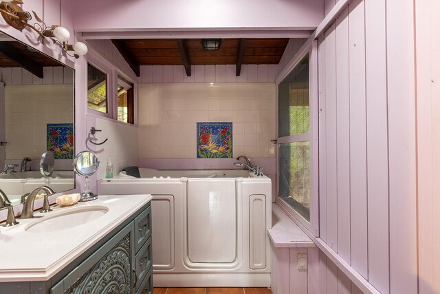 bathroom featuring vanity and a bath