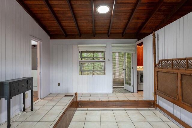 entryway featuring washer / clothes dryer, light tile patterned floors, wood ceiling, and vaulted ceiling with beams