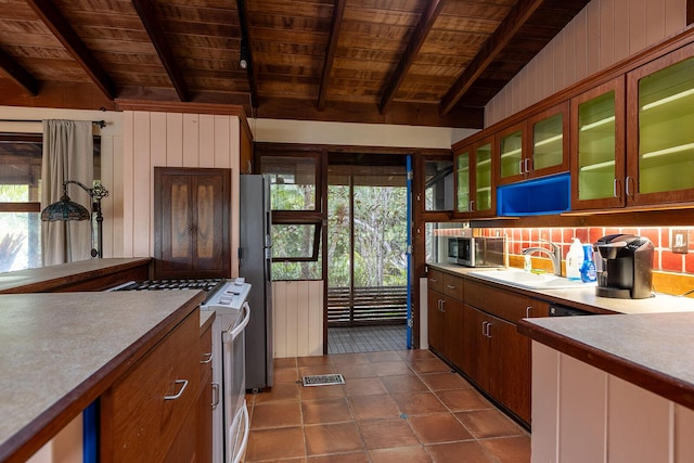 kitchen featuring stainless steel appliances, sink, wooden ceiling, and beamed ceiling