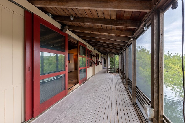 exterior space featuring wood ceiling, a healthy amount of sunlight, and vaulted ceiling with beams