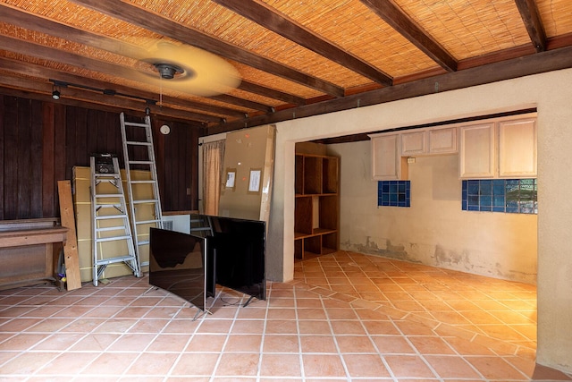 basement with light tile patterned floors and wood ceiling