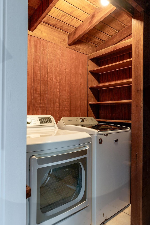 washroom featuring wooden ceiling, washing machine and clothes dryer, and wooden walls