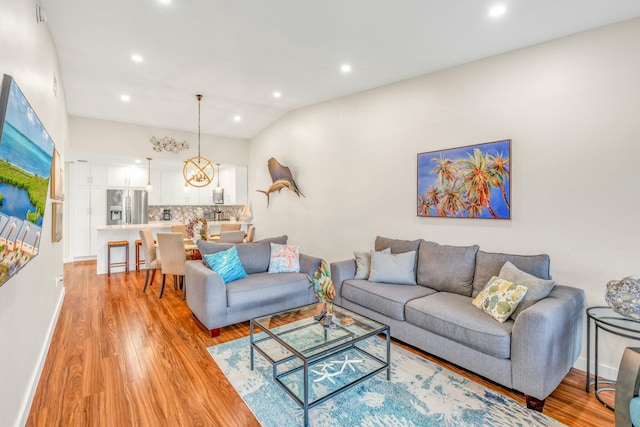 living room with recessed lighting, baseboards, lofted ceiling, and light wood-type flooring
