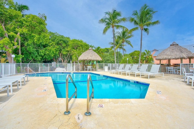 pool featuring a patio, fence, and a gazebo