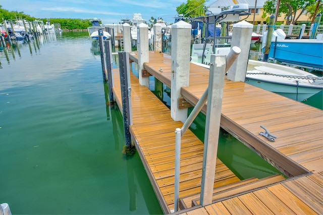 dock area with boat lift and a water view