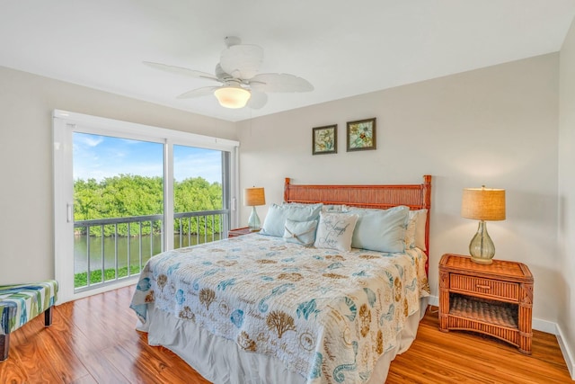 bedroom featuring baseboards, access to exterior, wood finished floors, and a ceiling fan