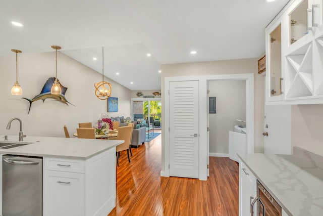 kitchen with a sink, white cabinetry, hanging light fixtures, light wood-type flooring, and recessed lighting