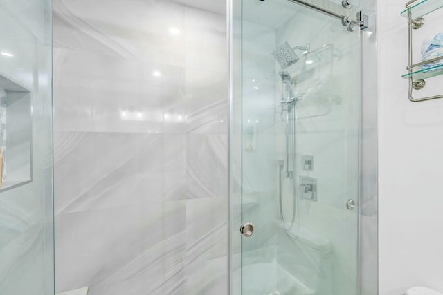 full bathroom with toilet and a stall shower