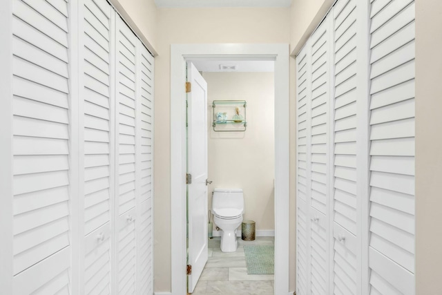 hall featuring baseboards