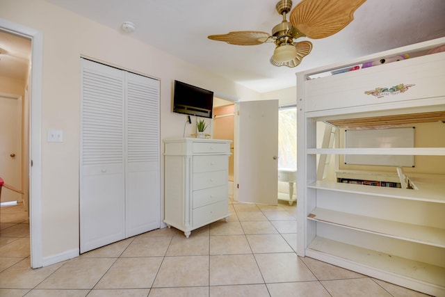 unfurnished bedroom featuring a closet, ceiling fan, and light tile patterned flooring