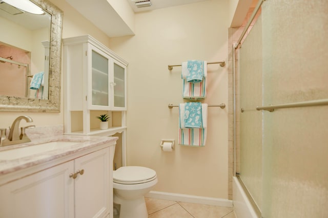 full bathroom with vanity, bath / shower combo with glass door, tile patterned floors, and toilet