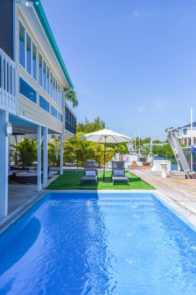 view of swimming pool featuring a patio and a lawn